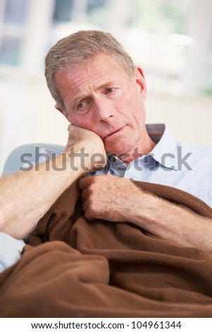 Sick, unhappy older man at home