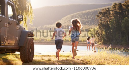 Excited Family Reaching Countryside Destination On Road Trip
