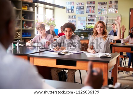 Male High School Tutor Teaching Students In Biology Class