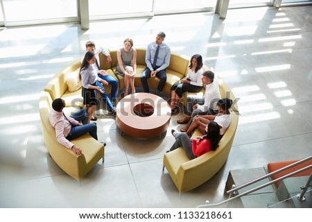 Meeting in a business lounge area, elevated view