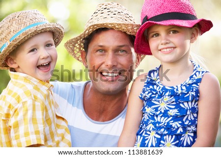 Father And Children Relaxing In Summer Garden