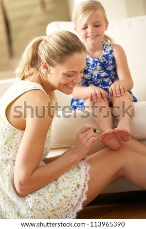 Mother Painting Daughter\'s Toenails At Home