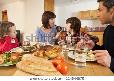 Family Having Argument Whilst Eating Lunch Together In Kitchen