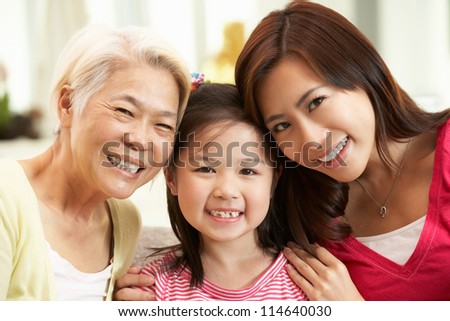 Female Multi Genenration Chinese Family Group Relaxing At HomeTogether