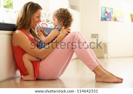 Mother Sitting With Daughter At Home