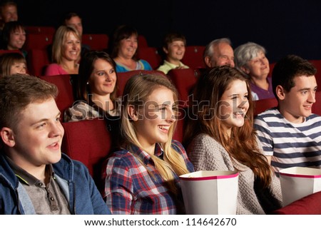 Group Of Teenage Friends Watching Film In Cinema