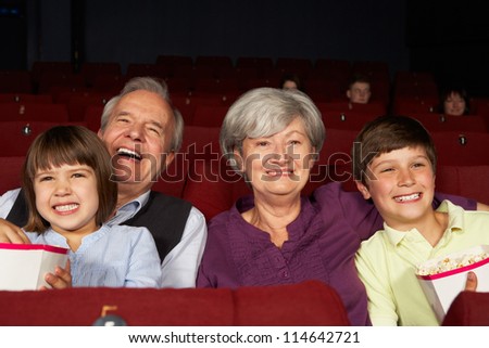 Grandparents Watching Film In Cinema With Grandchildren