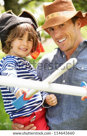 Father Playing Exciting Adventure Game With Son In Summer Field