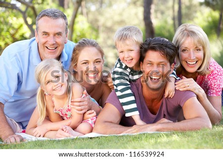 Extended Family Group Relaxing In Park Together