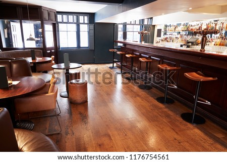 Interior Of Empty Bar With Stools And Counter