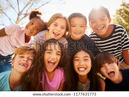 Multi-ethnic group of schoolchildren on school trip, smiling