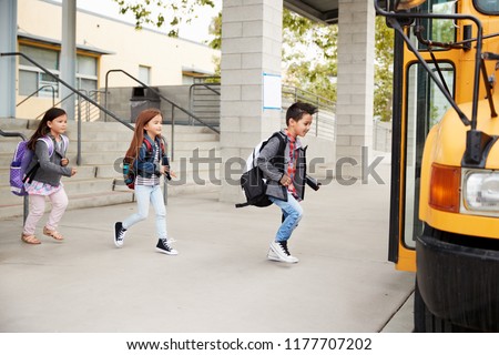 Elementary school kids leaving school to get the school bus