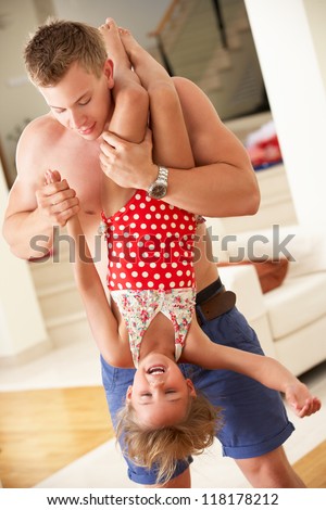 Father Holding Daughter Upside Down