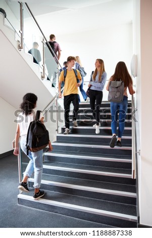 High School Students Walking On Stairs Between Lessons In Busy College Building
