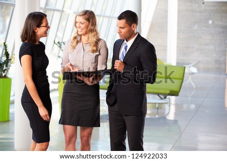 Businesspeople Having Informal Meeting In Modern Office
