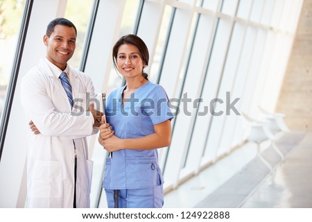 Portrait Of Medical Staff In Corridor Of Modern Hospital