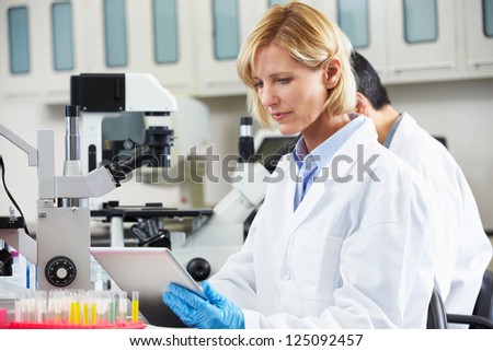 Female Scientist Using Tablet Computer In Laboratory