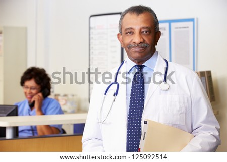 Portrait Of Doctor At Nurses Station