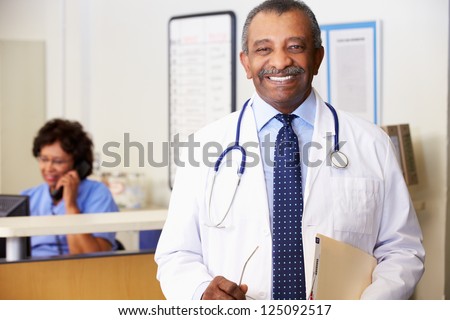 Portrait Of Doctor At Nurses Station