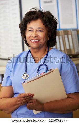 Female Nurse At Nurses Station
