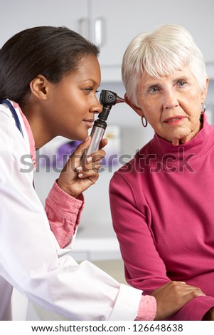 Doctor Examining Senior Female Patient\'s Ears