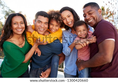 African American three generation family playing together in the garden, smiling to camera