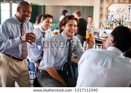 Group Of Businessmen Meeting For After Works Drinks In Bar