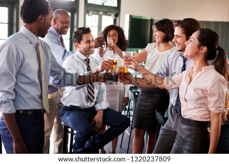 Business Colleagues Meeting For After Works Drinks In Bar Making A Toast