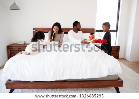 Children Bringing Parents Breakfast In Bed To Celebrate Mothers Day Fathers Day Or Birthday