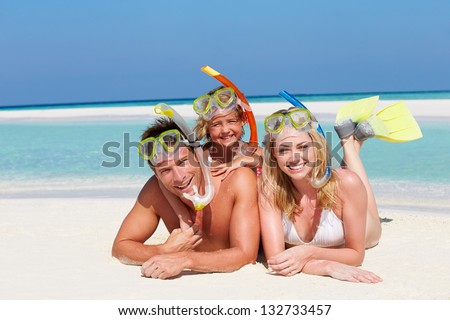 Family With Snorkels Enjoying Beach Holiday