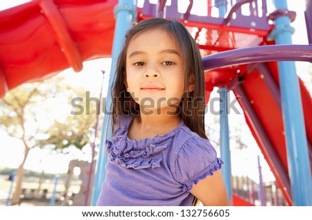 Girl On Climbing Frame In Park