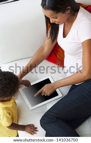Overhead View Of Mother And Son On Sofa Using Digital Tablet