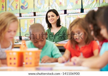 Group Of Elementary Age Children In Art Class With Teacher Group Of Elementary Age Children In Art Class With Teacher
