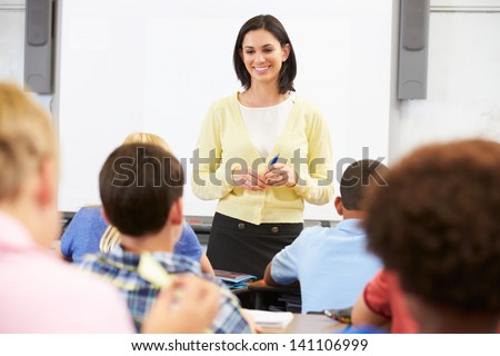 Teacher Standing In Front Of Class Of Pupils
