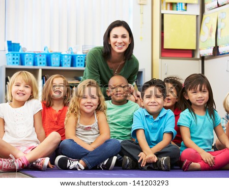 Group of Elementary Pupils In Classroom With Teacher