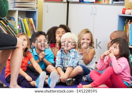 Group of Elementary Pupils In Classroom Touching Noses