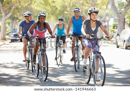 Group Of Cyclists On Suburban Street