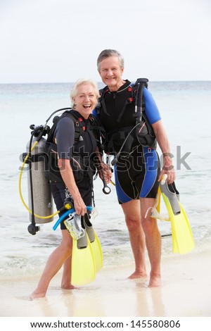 Senior Couple With Scuba Diving Equipment Enjoying Holiday