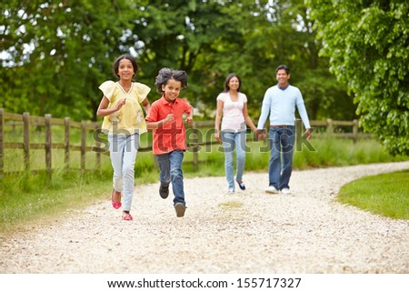 Indian Family Walking In Countryside