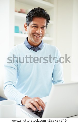 Indian Man Using Laptop At Home
