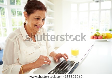 Senior Indian Woman Using Laptop At Home
