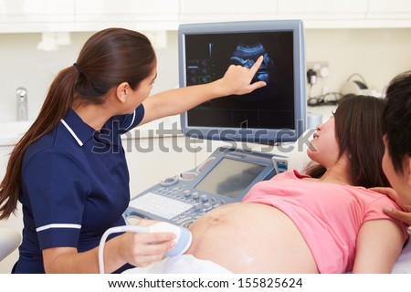 Pregnant Woman And Partner Having 4d Ultrasound Scan
