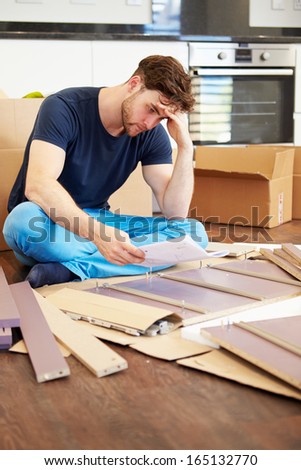 Frustrated Man Putting Together Self Assembly Furniture