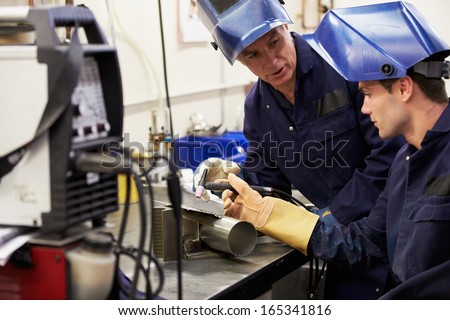 Engineer Teaching Apprentice To Use Tig Welding Machine