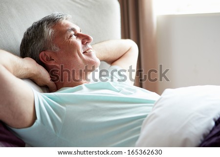 Middle Aged Man Waking Up In Bed