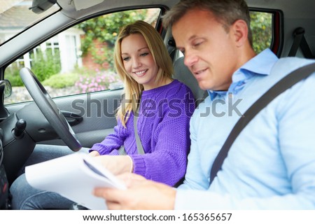Teenage Girl Having Driving Lesson With Instructor