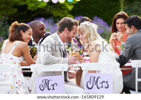 Bride And Groom Enjoying Meal At Wedding Reception