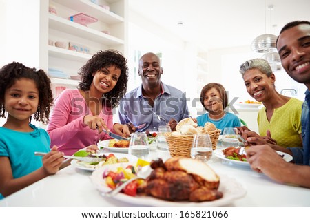 Multi Generation African American Family Eating Meal At Home
