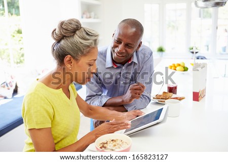 Mature African American Couple Using Digital Tablet At Home