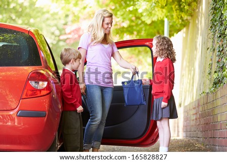 Mother Driving To School With Children